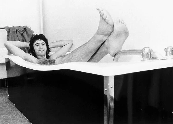 David Essex singer actor relaxes in a hot bath while on a hectic 52 date tour 1976