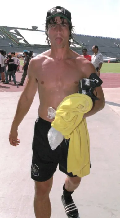 Framed Print : David Ginola pokes his tongue out after finishing a training session in Singapore