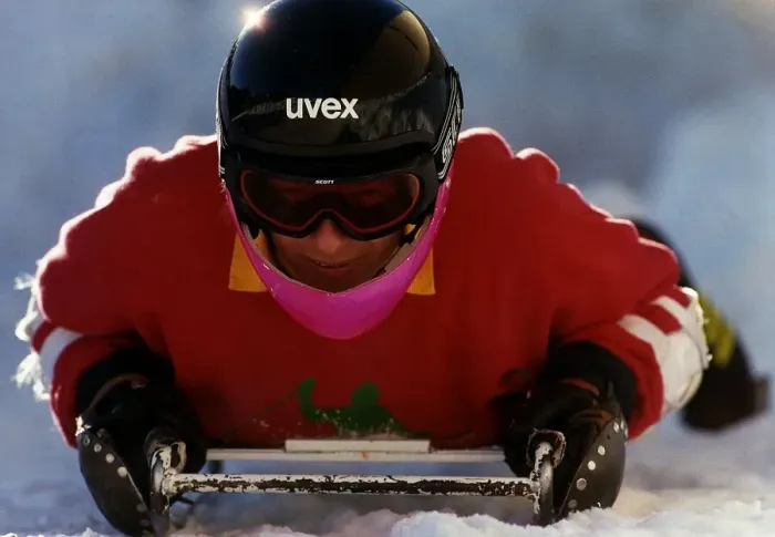 Framed Print : David Gower former England Cricket Captain lays on sledge in snow during a skiing break