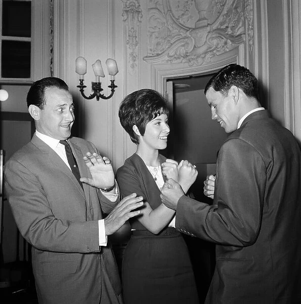 David Jacobs cowers behind singer Helen Shapiro as she 'shapes up'