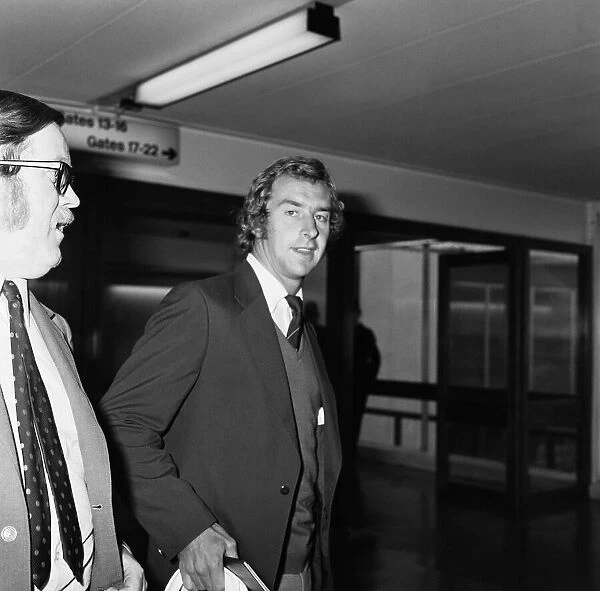David Lloyd (right) arriving back from Australia at Heathrow Airport