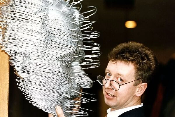 David Mack artist with his sculpture of human face made out of coat hangers