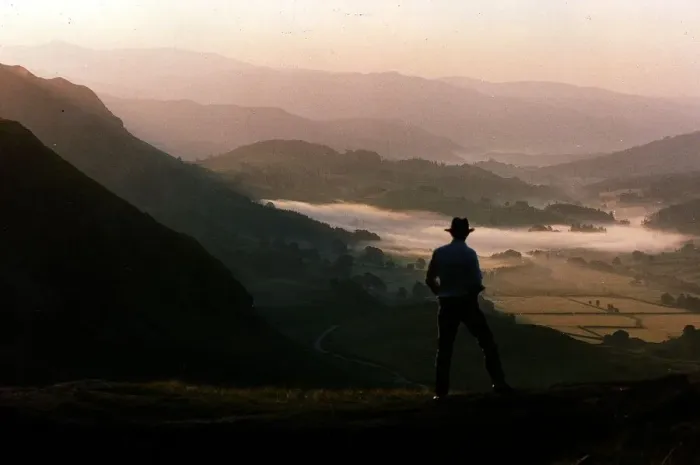 Framed Print : Dawn rises over the Lake District as a walker travels along a lakeland pass
