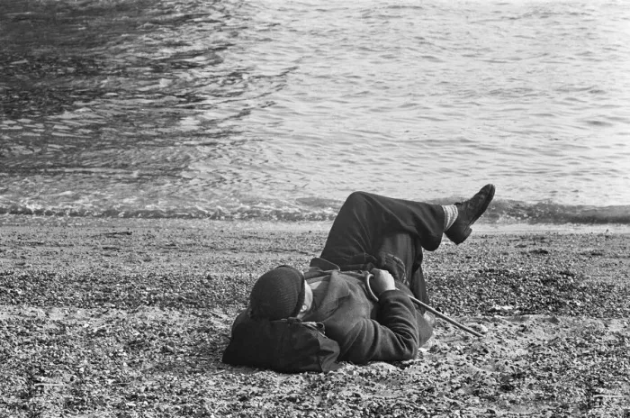 Framed Print : A day-tripper from Londons East End, relaxes in the summer sunshine on the beach Framed Print : A day-tripper from Londons East End, relaxes in the summer sunshine on the beach