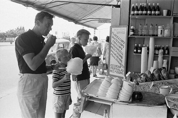 Day trippers from London enjoying candy floss, muscles and winkles from a sea food cafe
