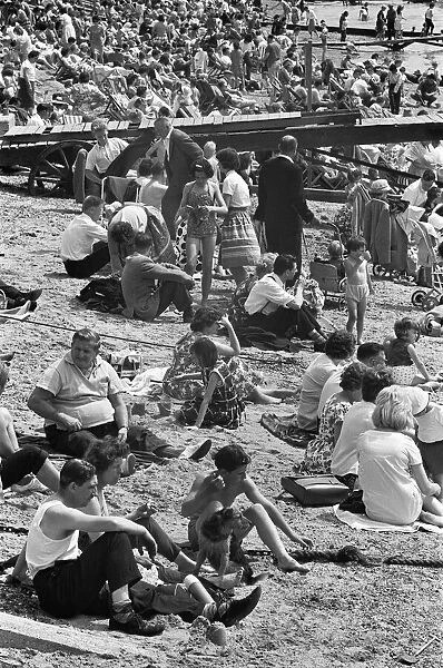 Day-trippers from Londons East End, relaxes in the summer sunshine on a crowded