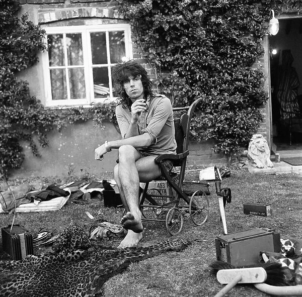 A dazed looking Keith Richards of The Rolling Stones sits outside his Redlands home
