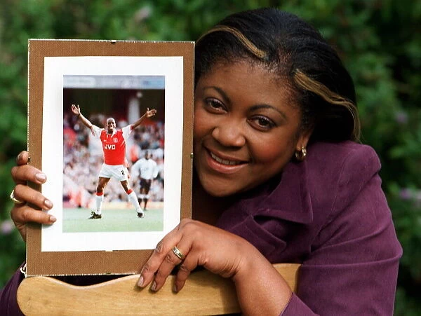 Debbie Wright wife of Ian Wright Football Player 1997 holding a picture