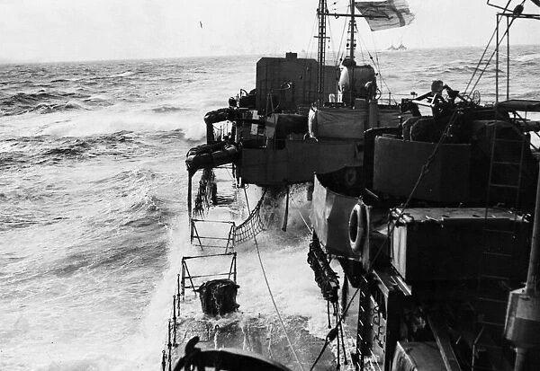 The decks of HMS Milne are awash as she ploughs through heavy seas in the North Atlantic