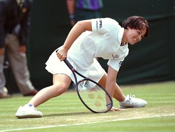 Defending champion Martina Hingis recovers from a slip