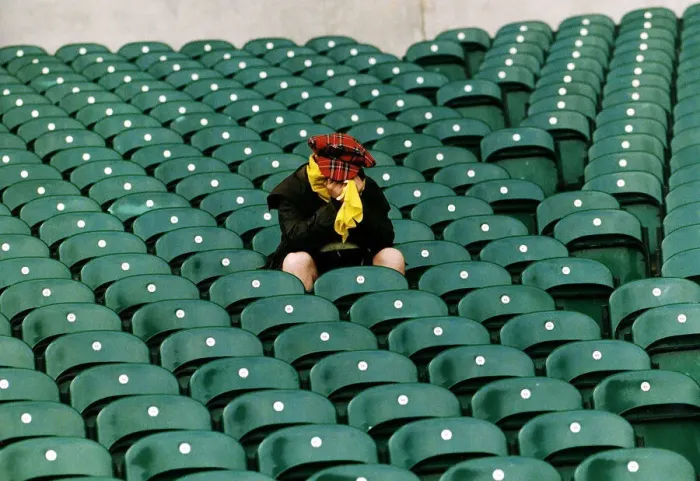 Framed Print : A dejected Scotland fan sits in a stadium with his head in his hands after his teams Framed Print : A dejected Scotland fan sits in a stadium with his head in his hands after his teams