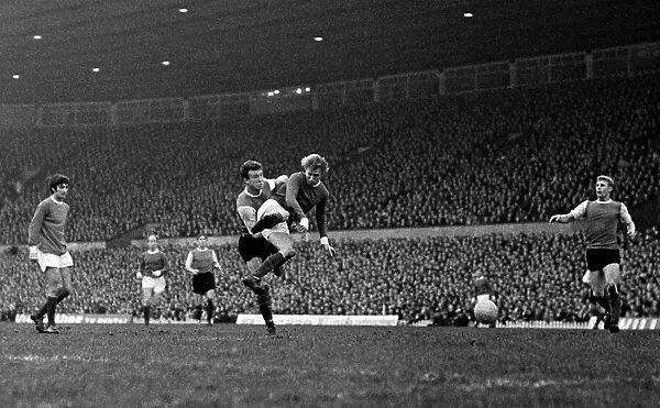 Denis Law of Manchester United beats a Sheffield Wednesday defender to fire a shot in