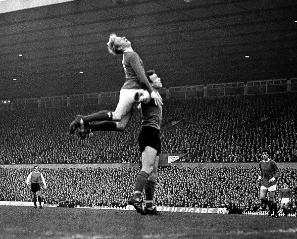 Denis Law of Manchester United jumps up for the ball during the league match against