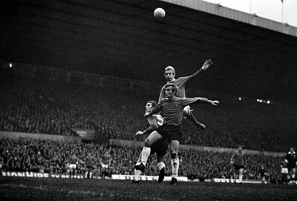 Denis Law of Manchester United jumps up for a high ball with Ipswich Town defenders