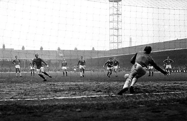 Denis Law scores for Manchester United from the penalty spot during the match against
