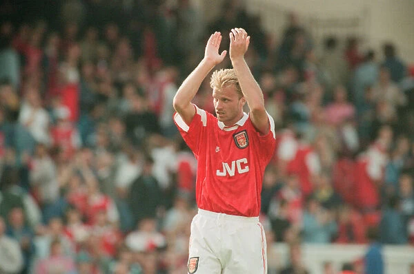 Dennis Bergkamp celebrates and applauds the fans for their support for his teams victory