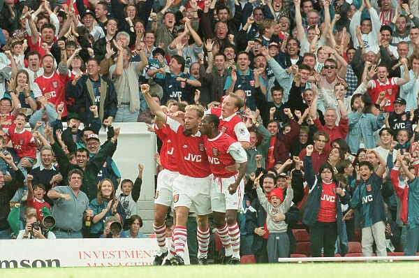 Dennis Bergkamp celebrates his first ever goal for his new club Arsenal