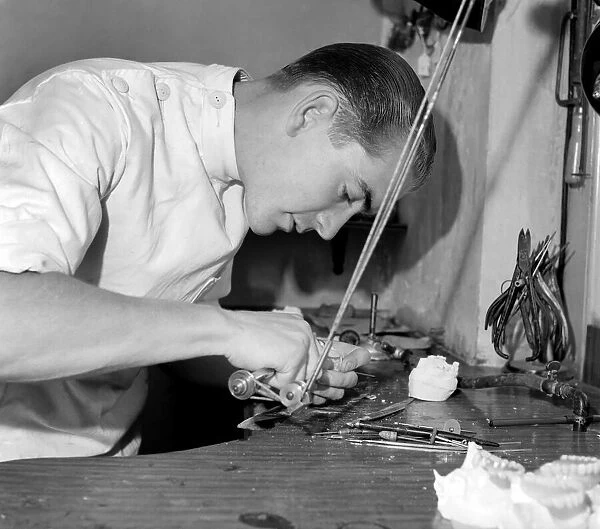 Dental mechanic watch repair. Mr. R. Guy at work in Lab. S. E. I. September 1953 D5549-001
