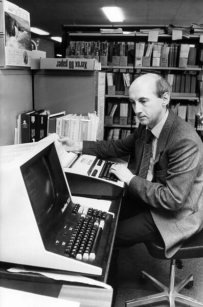 Deputy business and technical librarian Noel Hanson demonstrates the on-line computer