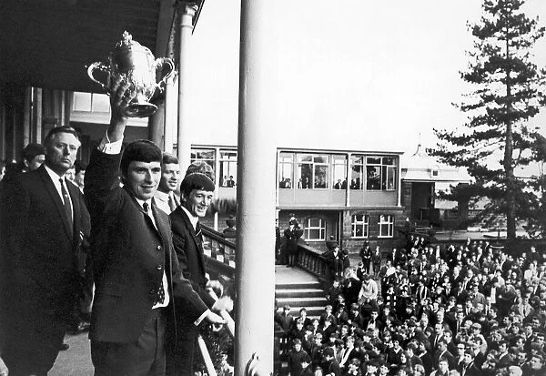Derby County footballer Kevin Hector proudly holds aloft the Division Two Championship