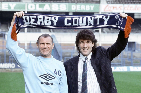 Derby County manager Arthur Cox with new signing Dean Saunders holding a club scarf aloft
