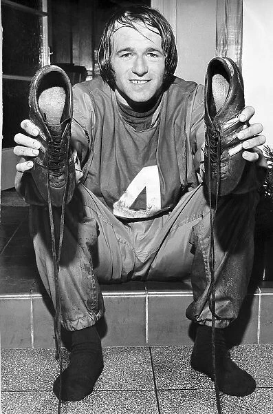 Derby County and Scotland international football player Archie Gemmill with boots