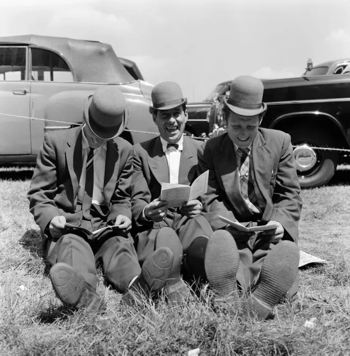 Framed Print : Derby Day at Epsom. Pictured, three lads from Newmarket sitting on the grass studying Framed Print : Derby Day at Epsom. Pictured, three lads from Newmarket sitting on the grass studying