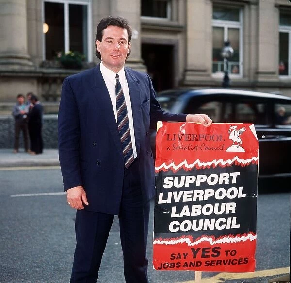 Derek Hatton of the Liverpool Labour Council holding a placard urging people to Support