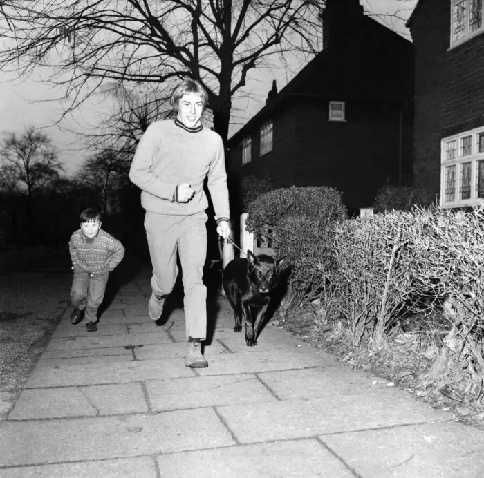 Framed Print : Derek Jeffries takes his dog Blackie for a run in a park near his home in Longsight Framed Print : Derek Jeffries takes his dog Blackie for a run in a park near his home in Longsight