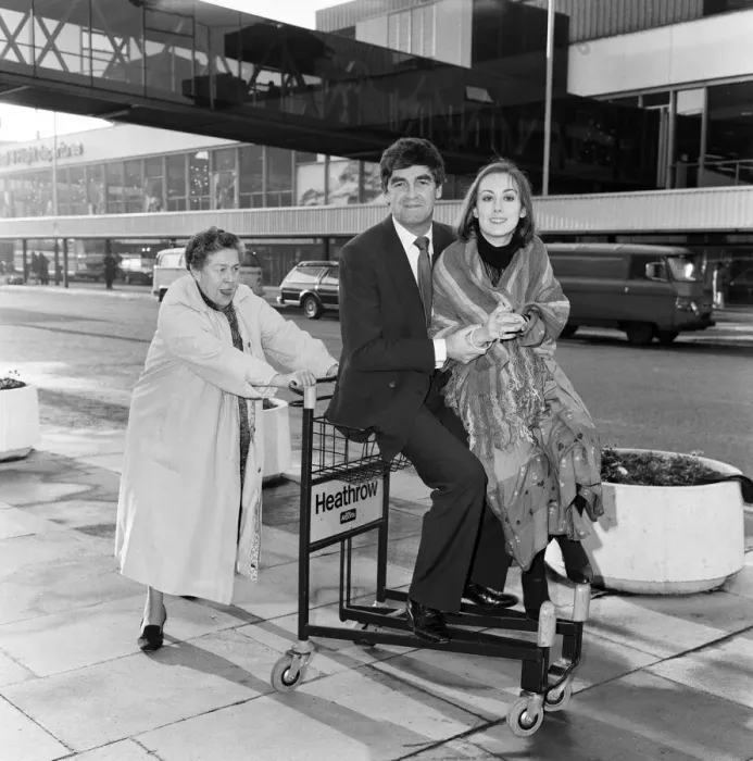 Framed Print : Derek Nimmo with Peggy Mount (left) and Paula Wilcox leaving Heathrow Airport for