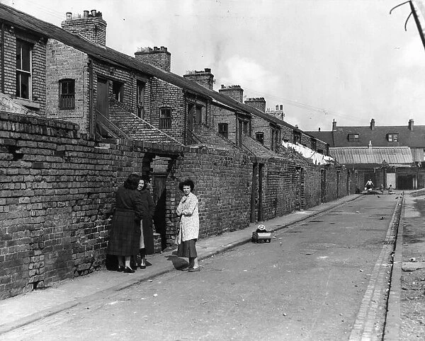 Derelict housing in an area of Newcastle - A group of women gossip in the back lane