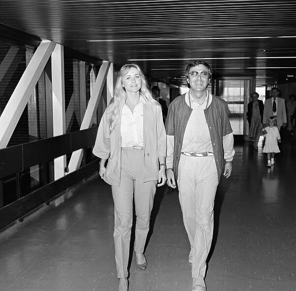 Des O Connor arriving at Heathrow Airport from Australia with his girlfriend Jay