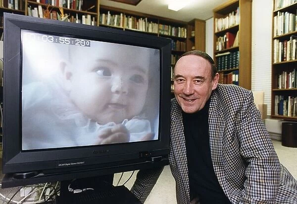 Desmond Morris anthropologist tv presenter baby watching at his home in Oxford Dbase