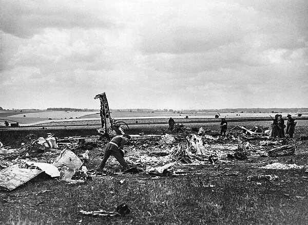 A destroyed Heinkel III bomber of the German Luftwaffe lies in a clover field in a small