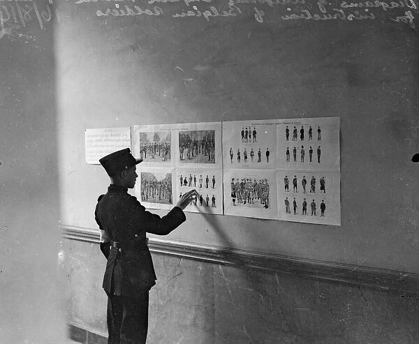 Diagrams of English, French and Belgian uniforms pinned to the wall for instruction of