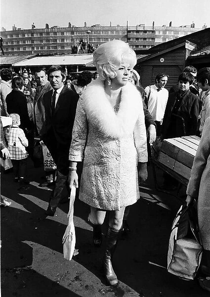 Diana Dors Actress walking throgh a busy market in Leeds Yorkshire Dbase MSI
