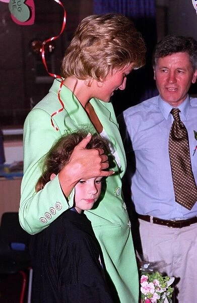Diana, Princess of Wales with her arm round Danielle Stephenson on avisit to a