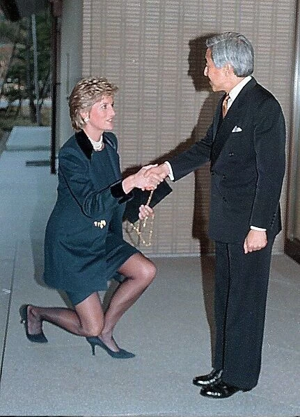 Diana, Princess of Wales curtsies as she greets Emperor Akihito of Japan during her visit