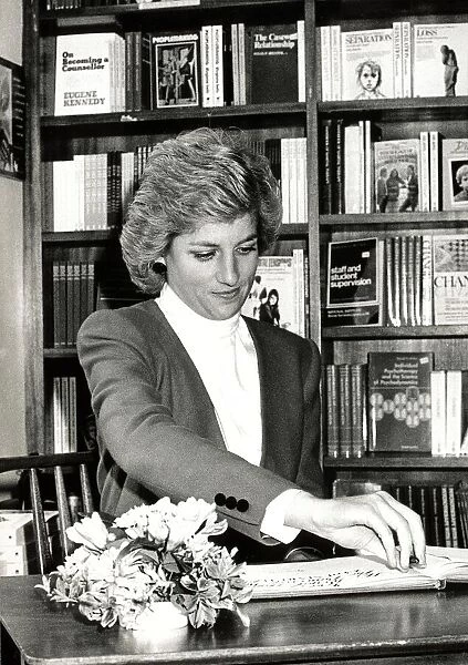 Diana, Princess of Wales during a visit to Rugby. She is seen here signing the RELATE