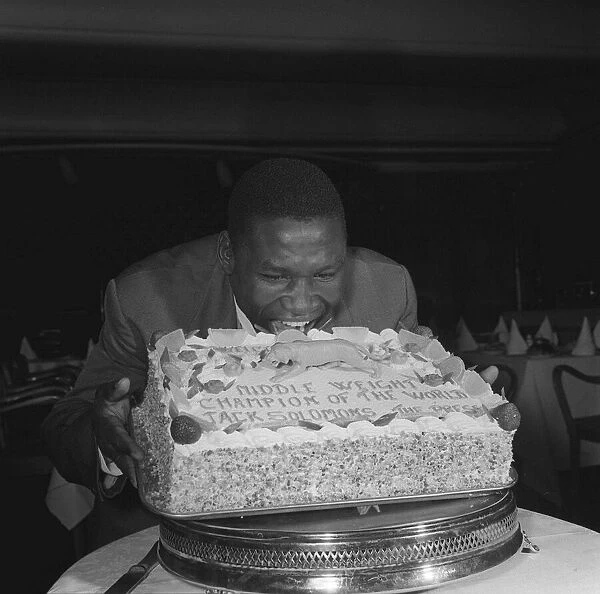 Dick Tiger Middleweight Boxing Champion eating his cake at a West End luncheon