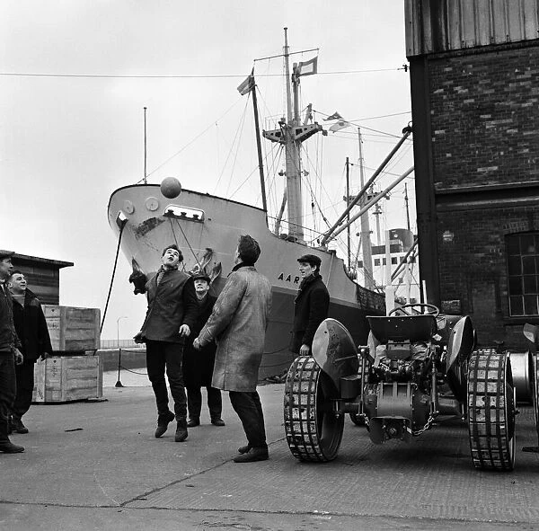 Its dinner break at the docks and these dockers get the ball out for a kick about in