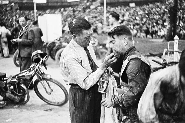 Dirt Track races in London. (Picture shows) A competitor receiving treatment for an