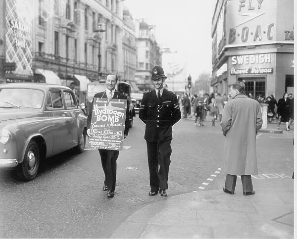 Disarmament meeting April 1954 Anthony Greenwood MP escorted by a policeman seen