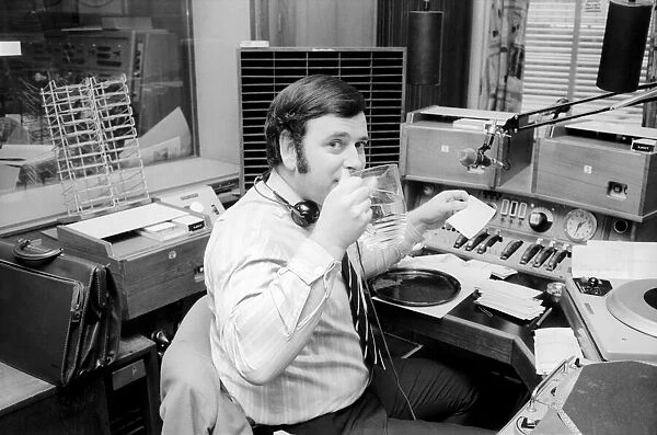 Disc Jockey Terry Wogan enjoys a large jug of water during broadcast of his afternoon