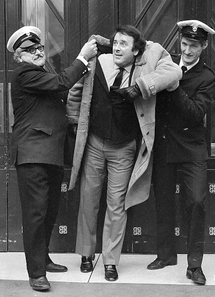 Disc jockey Terry Wogan is escorted off BBC premises, Broadcasting House