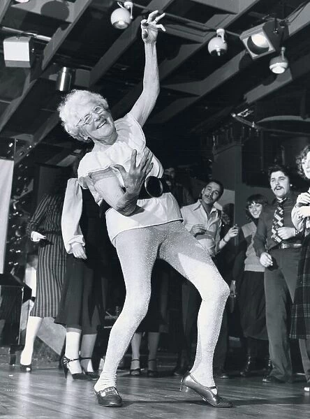 Disco dancing 93 year old Beattie Bradnam dances on the disco dance floor wearing a