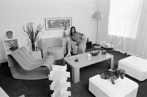 A display of modern furniture, a woman sitting in a modern living room space