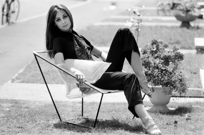 Framed Print : A display of modern furniture, a woman sitting on a transparent chair. 30th June 1969