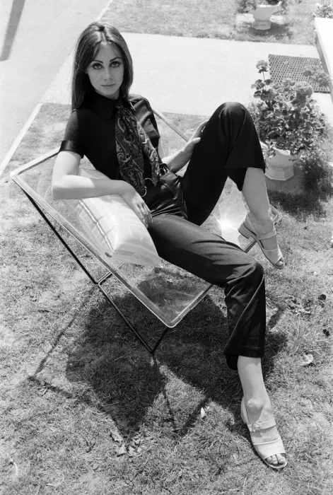 Framed Print : A display of modern furniture, a woman sitting on a transparent chair. 30th June 1969