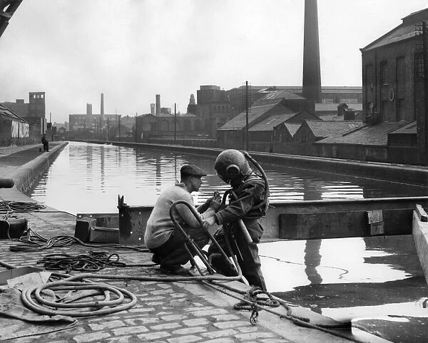 Diver Jack Ellis comes up from the river for a quick breather. September 1949